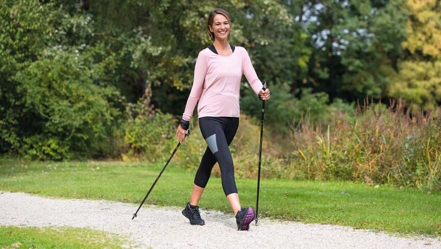 sieviete ir aizņemta staigājot, lai novērstu muguras sāpes